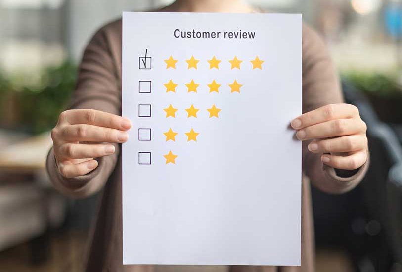 Image of person holding up review paper