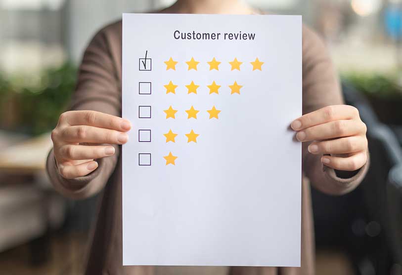 Image of person holding up review paper